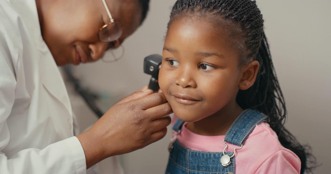Young girl undergoing an ear exam.