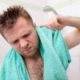 Man tries to remove water from his ears