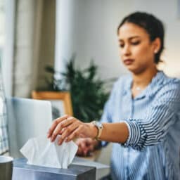 Blurred woman reaching for a tissue