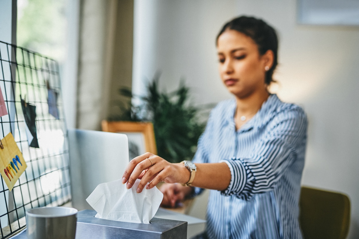 Blurred woman reaching for a tissue