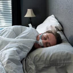 Man sleeping with a CPAP machine.