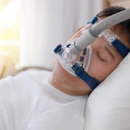 Man sleeping with a CPAP machine.