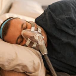 Man sleeping with a CPAP mask
