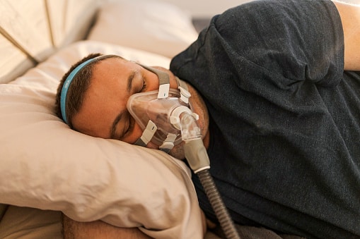 Man sleeping with a CPAP mask
