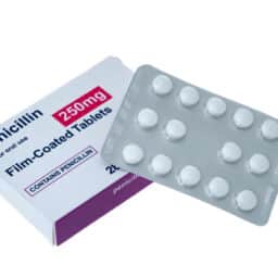 Penicillin box and pills - white background